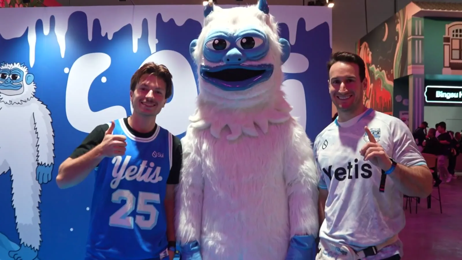 Miembros del equipo de Lofi posan con una mascota Yeti en el stand de Lofi en Sui Basecamp, en Singapur